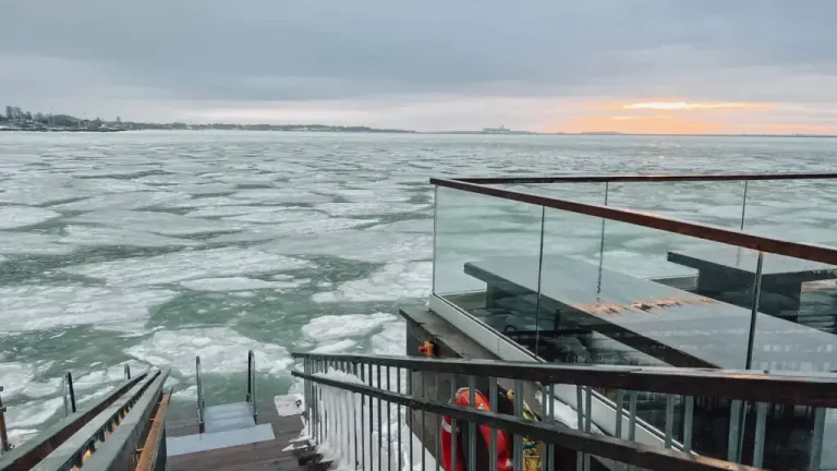 sunrise at Loyly Sauna from the hole in the ice.
