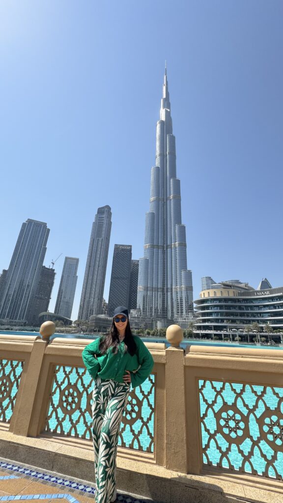 visit dubai for the first timers, Holly posing in front of the Burj Khalifa